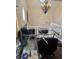 Well-lit home office space with a glass desk, modern chandelier, and contemporary wall art at 9649 Cedar Cove Ln, Indianapolis, IN 46250
