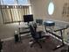 Functional home office with a glass-top desk, ergonomic chair, and natural light from a circular window at 9649 Cedar Cove Ln, Indianapolis, IN 46250
