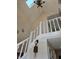 Elegant staircase with white railings, complemented by a skylight and decorative chandelier at 9649 Cedar Cove Ln, Indianapolis, IN 46250