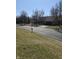 Scenic street view with a glimpse of the house, showing its proximity to a community lake and green space at 9649 Cedar Cove Ln, Indianapolis, IN 46250