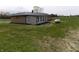 Exterior shot of the back of the home showcasing the sunroom and propane tank at 10966 W State Road 142, Quincy, IN 47456