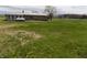 Exterior shot of backyard showing the sunroom and propane tank of the home at 10966 W State Road 142, Quincy, IN 47456