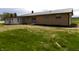 Exterior view of the backyard showing the sunroom of the single-story home at 10966 W State Road 142, Quincy, IN 47456