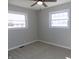 Bright bedroom with carpet flooring, ceiling fan and two windows providing ample natural light at 10966 W State Road 142, Quincy, IN 47456