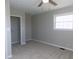 Bedroom features carpet flooring, a ceiling fan, a window and an open closet at 10966 W State Road 142, Quincy, IN 47456