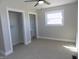 Spacious bedroom features carpet flooring, dual closets and a large window at 10966 W State Road 142, Quincy, IN 47456