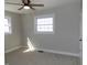 Bright bedroom with carpet flooring, ceiling fan, two windows providing ample natural light at 10966 W State Road 142, Quincy, IN 47456