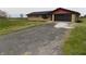 Lovely single-story brick home featuring an attached garage and a gravel driveway at 10966 W State Road 142, Quincy, IN 47456