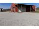 Detached red building with white door and garage door, surrounded by gravel at 10966 W State Road 142, Quincy, IN 47456