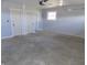 Modern garage with automatic door, ample lighting, and multiple interior doors at 10966 W State Road 142, Quincy, IN 47456
