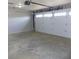 Spacious garage with concrete floor, overhead lighting and automatic door at 10966 W State Road 142, Quincy, IN 47456