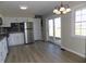 Modern kitchen with white cabinets, stainless steel appliances, and a door leading to the backyard at 10966 W State Road 142, Quincy, IN 47456