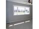 Bright living room features a large bay window offering ample natural light and neutral walls at 10966 W State Road 142, Quincy, IN 47456