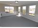 Bright living room with carpeting, wainscoting, and several windows for ample natural light at 10966 W State Road 142, Quincy, IN 47456