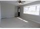 Bright living room with a front door, a ceiling fan and a big bay window offering ample natural light at 10966 W State Road 142, Quincy, IN 47456