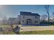 Back exterior showcasing a large yard, above ground pool with a patio, and classic home architecture at 11144 Echo Trl, Indianapolis, IN 46236