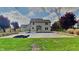Home's back exterior displays a pool, concrete patio and manicured lawn creating a relaxing outdoor living space at 11144 Echo Trl, Indianapolis, IN 46236