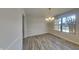 Bright dining room showcasing wood floors, a modern light fixture, with a view out of a large window at 11144 Echo Trl, Indianapolis, IN 46236