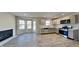 Open kitchen featuring modern cabinets, stainless appliances, an eat-in area with fireplace and outdoor access at 11144 Echo Trl, Indianapolis, IN 46236