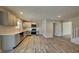 Modern kitchen featuring stainless appliances, light gray cabinetry, and hardwood floors at 11144 Echo Trl, Indianapolis, IN 46236