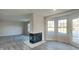 Bright living room showcasing plank flooring, a modern fireplace, and natural light from large windows at 11144 Echo Trl, Indianapolis, IN 46236