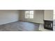 Bright living room featuring plank flooring, fireplace and lots of natural light coming through a window at 11144 Echo Trl, Indianapolis, IN 46236