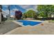 Backyard pool featuring concrete patio, wooden fence, and lush greenery providing a serene outdoor space at 11144 Echo Trl, Indianapolis, IN 46236