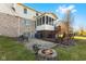Backyard patio and deck with fire pit, perfect for outdoor entertaining and enjoying the serene surroundings at 1146 Mount Vernon Dr, Greenwood, IN 46142