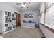 Cozy bedroom with a daybed, a bookshelf filled with books, and a ceiling fan for added comfort at 1146 Mount Vernon Dr, Greenwood, IN 46142