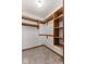 Walk-in closet featuring carpeted floors, built in wooden shelving and hanging storage options at 1146 Mount Vernon Dr, Greenwood, IN 46142