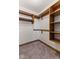 Walk-in closet featuring carpeted floors, built in wooden shelving and hanging storage options at 1146 Mount Vernon Dr, Greenwood, IN 46142