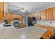 Open kitchen with granite countertops, wood cabinets, stainless appliances, and tiled backsplash at 1146 Mount Vernon Dr, Greenwood, IN 46142