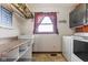 Functional laundry room with utility sink, vintage washer, and storage at 1146 Mount Vernon Dr, Greenwood, IN 46142