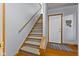 Carpeted stairway leading to the upper level with natural wood trim and handrail at 1146 Mount Vernon Dr, Greenwood, IN 46142