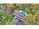 Overhead shot of house boasting a large driveway, and a backyard oasis with pool and mature trees at 11796 Sycamore St, Zionsville, IN 46077