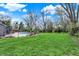 Expansive backyard with lush green lawn, mature trees, and inviting pool area, perfect for outdoor activities at 11796 Sycamore St, Zionsville, IN 46077