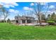 Beautiful backyard featuring mature trees, green grass and an in-ground pool at 11796 Sycamore St, Zionsville, IN 46077