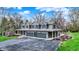 Exterior view featuring an attached three-car garage, covered porch, and professional landscaping at 11796 Sycamore St, Zionsville, IN 46077