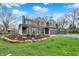 Stunning two-story home featuring a three-car garage, covered porch, and professionally landscaped front yard at 11796 Sycamore St, Zionsville, IN 46077