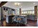 Chef's kitchen featuring granite countertops, stainless steel appliances, and a large island with bar seating at 11796 Sycamore St, Zionsville, IN 46077