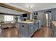 Open-concept kitchen with a large island, stainless steel appliances, and easy access to the living room at 11796 Sycamore St, Zionsville, IN 46077