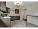 Functional kitchenette featuring ample cabinet space, a stylish light fixture, and white countertops at 11796 Sycamore St, Zionsville, IN 46077