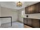 Well-lit kitchenette with abundant storage, a view to the backyard, and a small table at 11796 Sycamore St, Zionsville, IN 46077