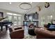Inviting living room with a grand piano, comfortable leather seating, and a stylish bar area at 11796 Sycamore St, Zionsville, IN 46077