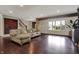 Expansive living room featuring hardwood floors, large windows, and a comfortable sectional sofa at 11796 Sycamore St, Zionsville, IN 46077