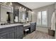 Beautiful main bathroom with double sinks, black accent wall, and shuttered window at 11796 Sycamore St, Zionsville, IN 46077