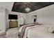 Relaxing main bedroom with a trey ceiling, a large bed, and a dresser with TV at 11796 Sycamore St, Zionsville, IN 46077
