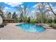 Inviting in-ground pool with stone surround and seating area, perfect for outdoor entertaining at 11796 Sycamore St, Zionsville, IN 46077