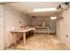 Unfinished basement storage area with work table at 1622 N Linwood Ave, Indianapolis, IN 46218
