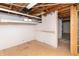 Unfinished basement features shelving and doorway to adjacent room at 1622 N Linwood Ave, Indianapolis, IN 46218